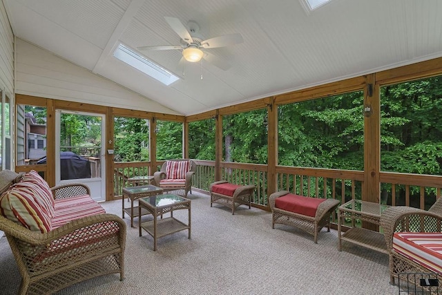 sunroom / solarium with a skylight, ceiling fan, lofted ceiling, and an outdoor living space