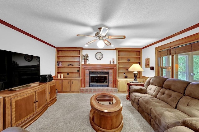 living room with a brick fireplace, crown molding, light colored carpet, ceiling fan, and a textured ceiling