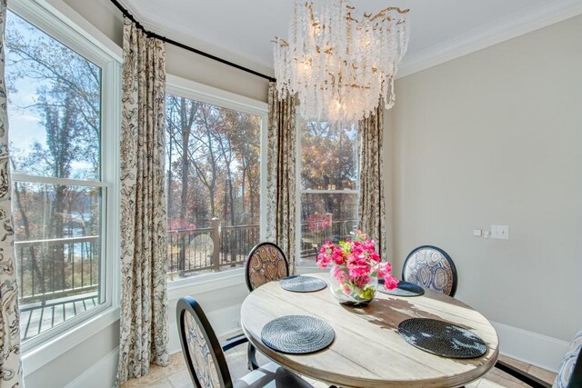 dining space featuring crown molding and a notable chandelier