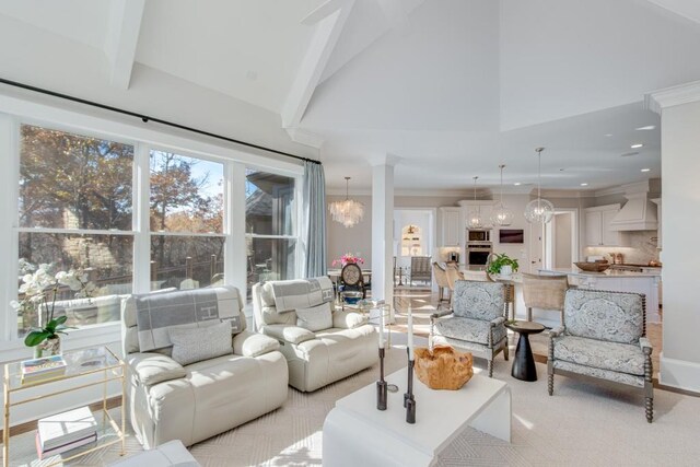 living room featuring ornamental molding, light colored carpet, high vaulted ceiling, a notable chandelier, and beamed ceiling