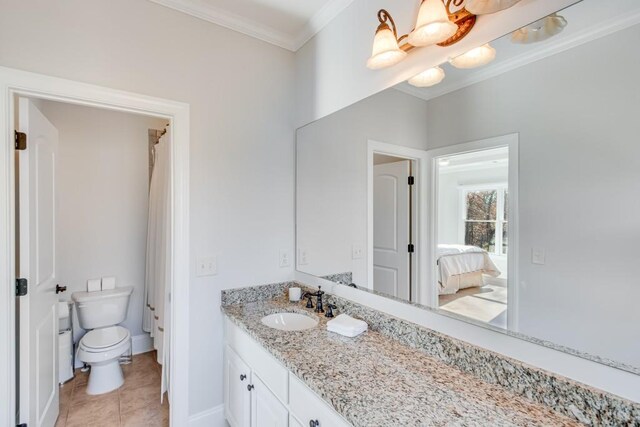 bathroom featuring tile patterned floors, vanity, toilet, and ornamental molding