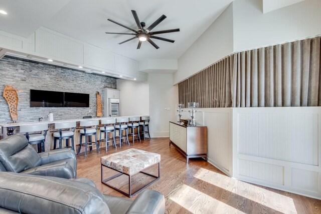 living room featuring ceiling fan and light hardwood / wood-style floors