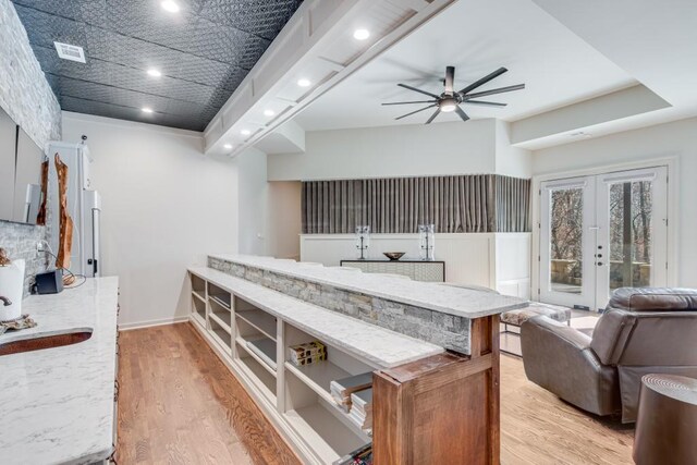 kitchen with french doors, light hardwood / wood-style flooring, ceiling fan, and sink