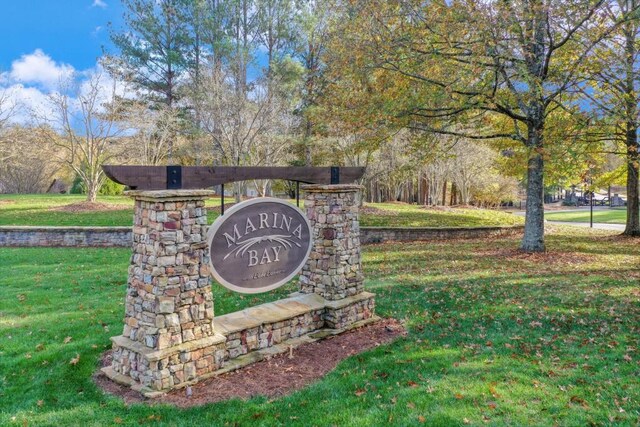 community / neighborhood sign featuring a yard