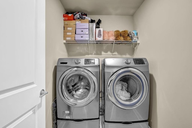 clothes washing area with washer and dryer