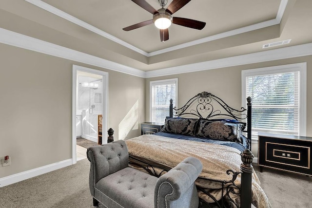 carpeted bedroom with connected bathroom, ornamental molding, a raised ceiling, and ceiling fan