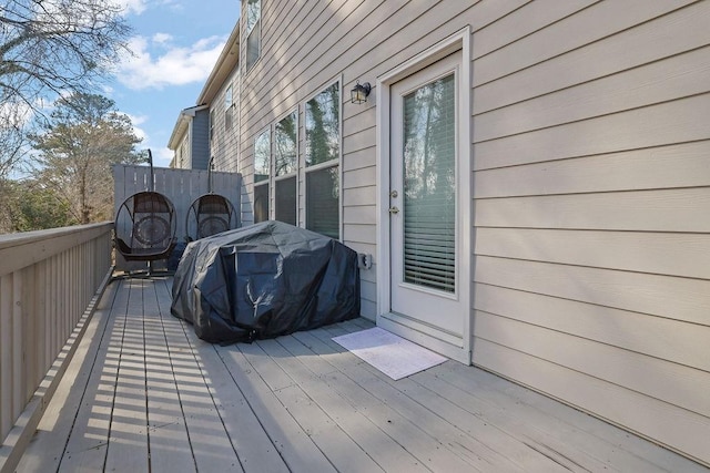 wooden terrace with a grill