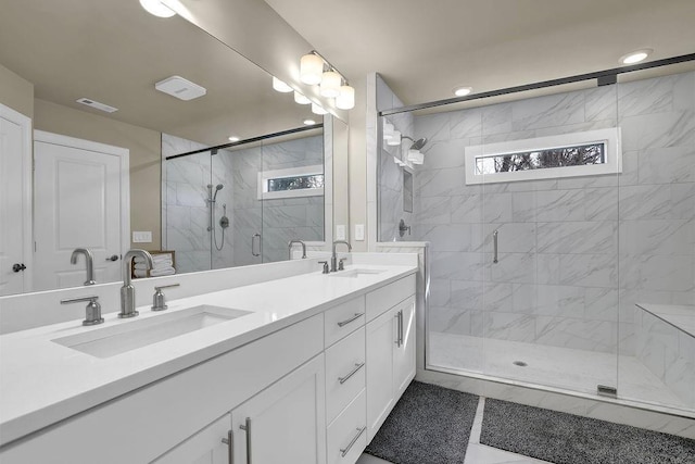 bathroom featuring vanity and a shower with shower door