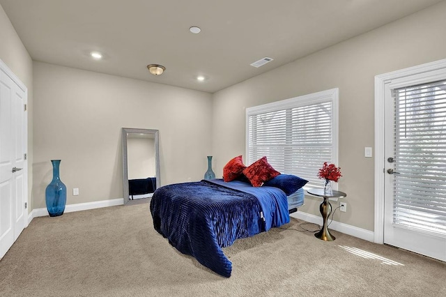 bedroom featuring access to outside and light colored carpet