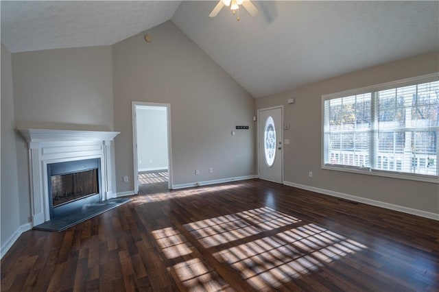 unfurnished living room with dark hardwood / wood-style floors, ceiling fan, and high vaulted ceiling