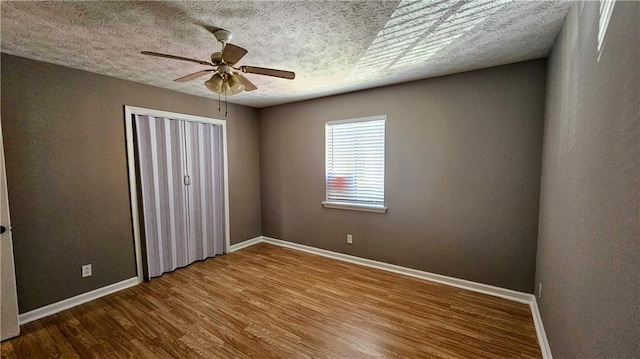 2388 Lawrenceville Hwy Unit D, Decatur, GA 30033 - unfurnished bedroom featuring a closet, baseboards, a ceiling fan, and wood finished floors