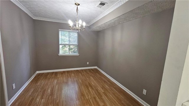 2388 Lawrenceville Hwy Unit D, Decatur, GA 30033 - unfurnished dining area featuring visible vents, a notable chandelier, ornamental molding, a textured ceiling, and dark wood finished floors