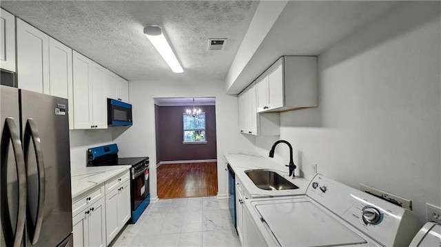 2388 Lawrenceville Hwy Unit D, Decatur, GA 30033 - clothes washing area with visible vents, washer and dryer, a sink, laundry area, and a textured ceiling