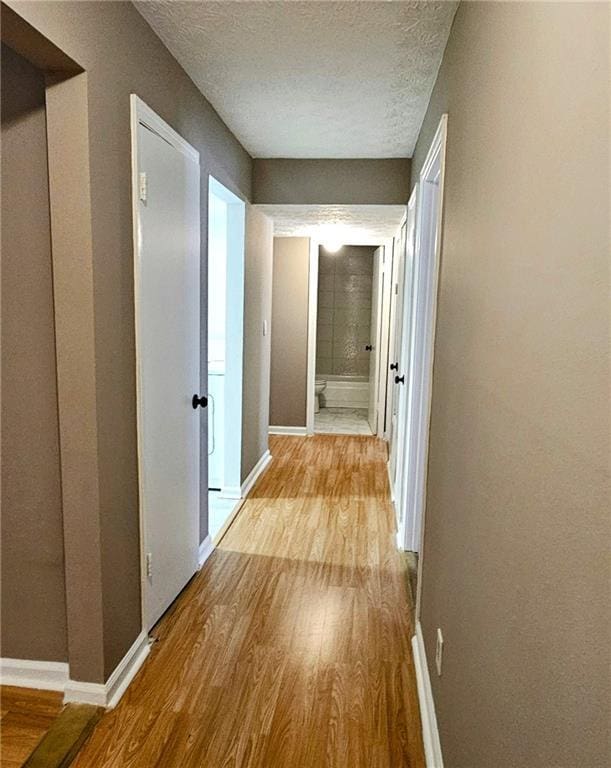 2388 Lawrenceville Hwy Unit D, Decatur, GA 30033 - hallway with a textured ceiling, wood finished floors, and baseboards