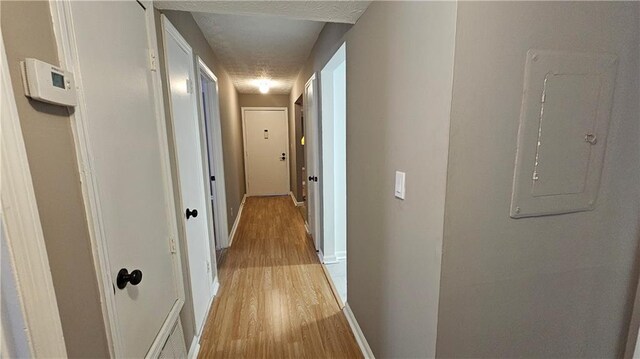 2388 Lawrenceville Hwy Unit D, Decatur, GA 30033 - corridor featuring baseboards, light wood-type flooring, and electric panel