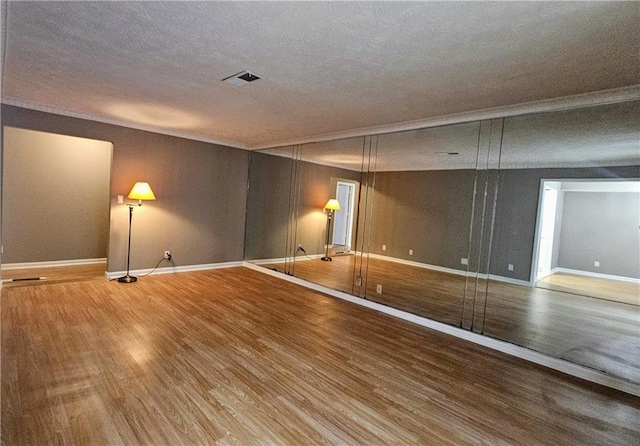2388 Lawrenceville Hwy Unit D, Decatur, GA 30033 - unfurnished room featuring crown molding, visible vents, baseboards, and wood finished floors