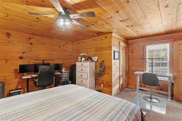 bedroom with wood walls, ceiling fan, wood ceiling, and light carpet