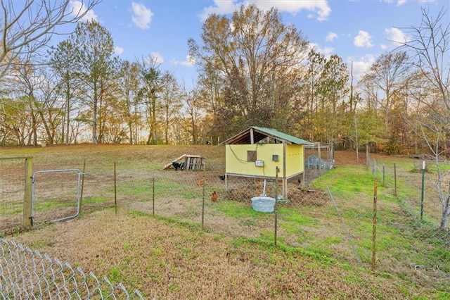 view of yard with a rural view and an outdoor structure