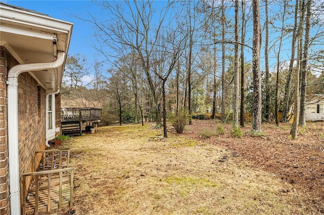 view of yard with a wooden deck