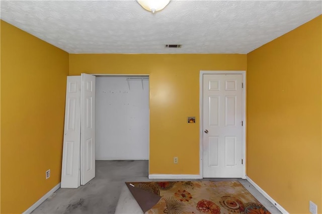 9550 Canvasback Ct, Jonesboro, GA 30238 - unfurnished bedroom with a closet, baseboards, and a textured ceiling