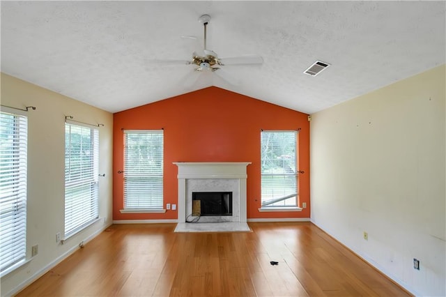 9550 Canvasback Ct, Jonesboro, GA 30238 - unfurnished living room with a ceiling fan, a fireplace, wood finished floors, a textured ceiling, and vaulted ceiling