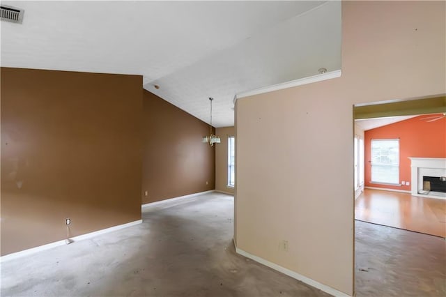9550 Canvasback Ct, Jonesboro, GA 30238 - unfurnished room with lofted ceiling, plenty of natural light, baseboards, a fireplace with flush hearth, and a chandelier