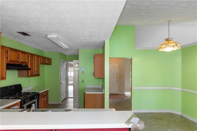 9550 Canvasback Ct, Jonesboro, GA 30238 - kitchen with under cabinet range hood, black gas range oven, a textured ceiling, light countertops, and baseboards
