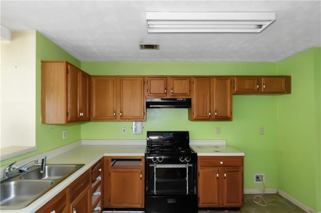 9550 Canvasback Ct, Jonesboro, GA 30238 - kitchen featuring black range with gas cooktop, under cabinet range hood, a sink, light countertops, and brown cabinetry