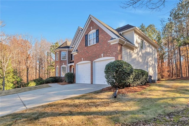 view of side of home featuring a garage and a yard