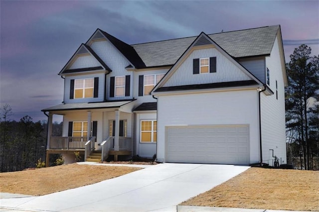 view of front facade with a porch, concrete driveway, and a garage