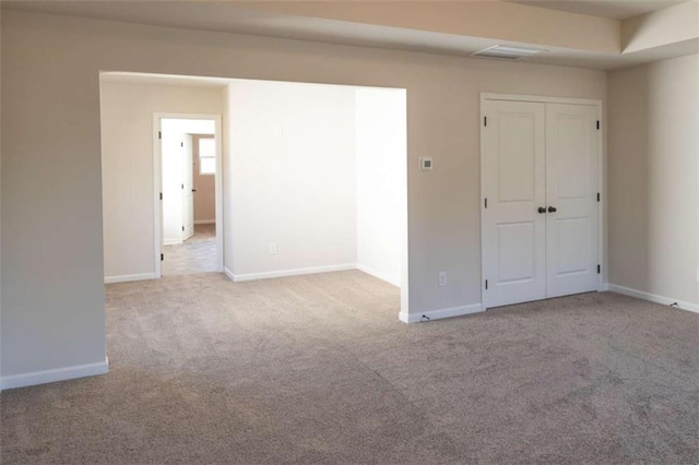 unfurnished bedroom with carpet floors, a closet, and baseboards