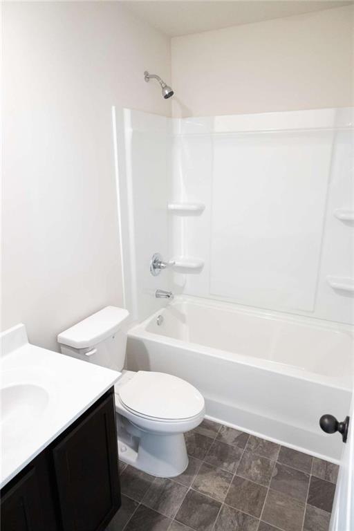 full bathroom with shower / bathing tub combination, vanity, and toilet