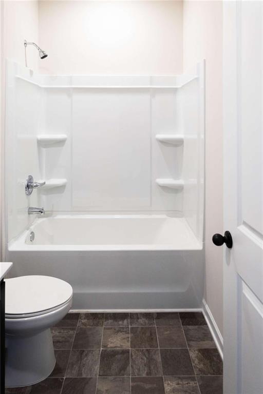 full bath with  shower combination, vanity, and toilet