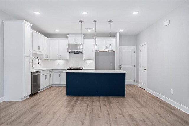 kitchen with white cabinets, light countertops, stainless steel dishwasher, a center island, and pendant lighting