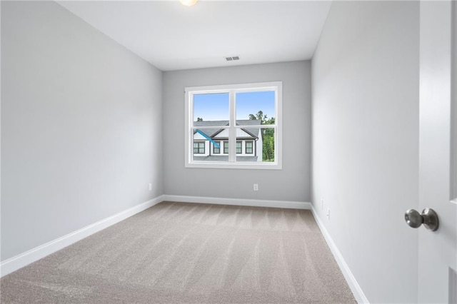 unfurnished room featuring carpet floors, baseboards, and visible vents