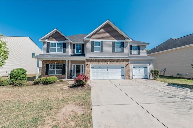 view of front facade featuring a front yard, an attached garage, brick siding, and driveway