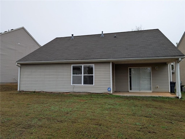 back of house featuring a patio and a yard