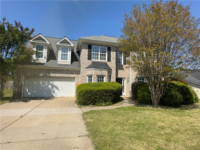 traditional-style house with an attached garage, concrete driveway, and a front yard
