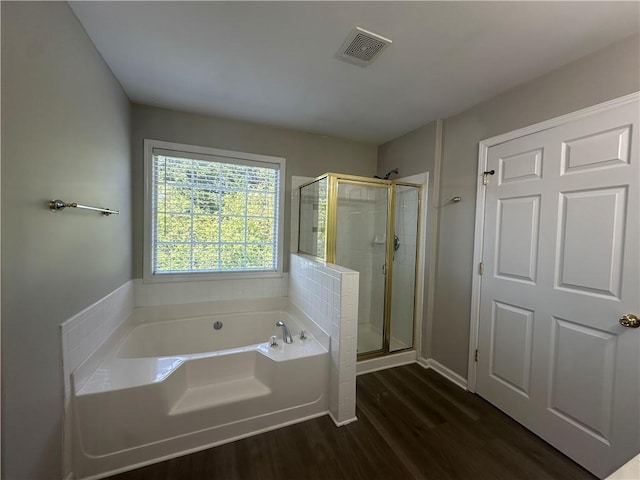 full bath featuring visible vents, wood finished floors, a bath, and a shower stall
