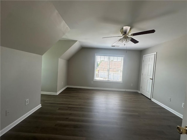 bonus room featuring a ceiling fan, baseboards, visible vents, and dark wood finished floors