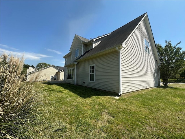 view of side of property with a lawn