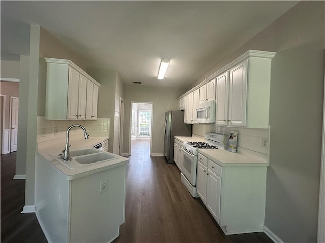 kitchen featuring a sink, white appliances, light countertops, baseboards, and decorative backsplash