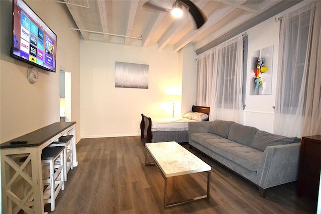 living room featuring a ceiling fan, dark wood finished floors, beam ceiling, and baseboards