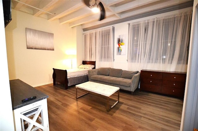 living area featuring beam ceiling and dark wood-style flooring