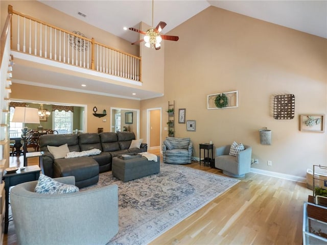 4523 Warwick Glen Pl, Flowery Branch, GA 30542 - living area with wood finished floors, ceiling fan, high vaulted ceiling, baseboards, and a chandelier