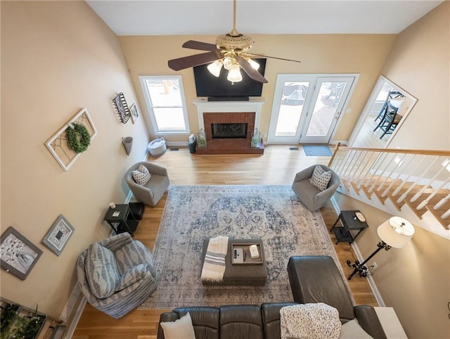 4523 Warwick Glen Pl, Flowery Branch, GA 30542 - living area with ceiling fan, wood finished floors, a fireplace, and baseboards