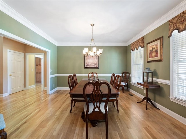 4523 Warwick Glen Pl, Flowery Branch, GA 30542 - dining room featuring a chandelier, crown molding, light wood-type flooring, and baseboards