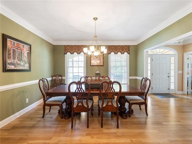 4523 Warwick Glen Pl, Flowery Branch, GA 30542 - dining room featuring a chandelier, light wood-style floors, crown molding, and baseboards