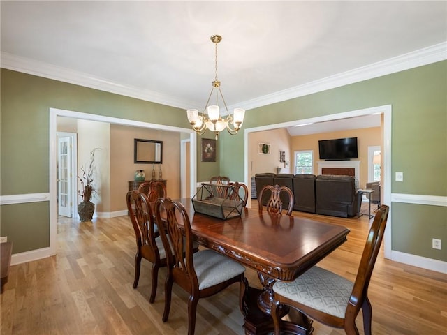 4523 Warwick Glen Pl, Flowery Branch, GA 30542 - dining area featuring a chandelier, light wood-style floors, ornamental molding, and baseboards