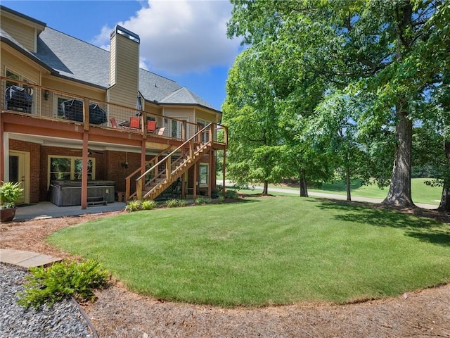 4523 Warwick Glen Pl, Flowery Branch, GA 30542 - view of grassy yard featuring a hot tub, stairway, a deck, and a patio area